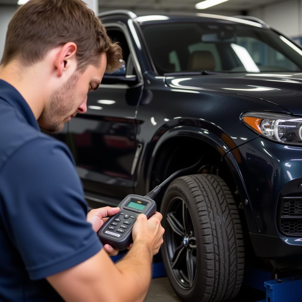 Mechanic Resetting the Brake Pad Warning Light on a BMW X3 using a Diagnostic Tool